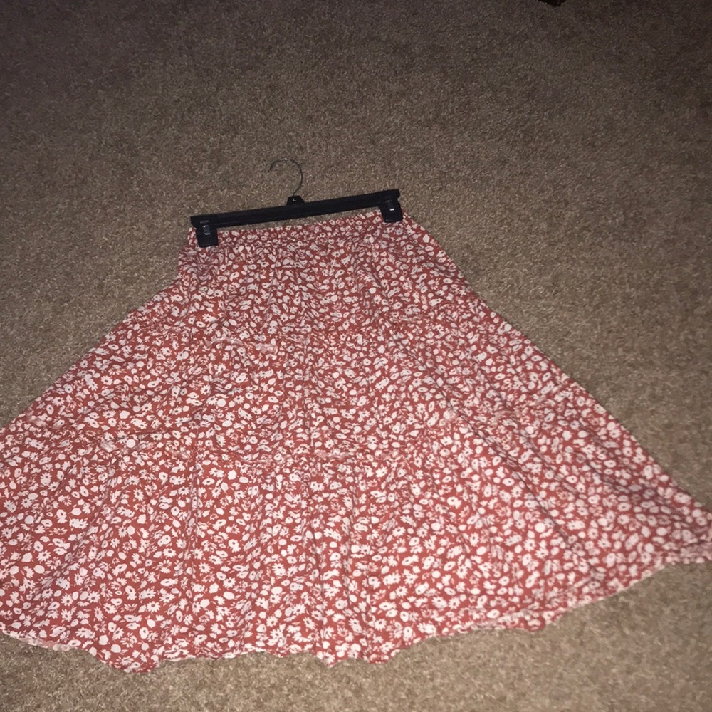 Vintage skirt with flower pattern and burnt orange background color.